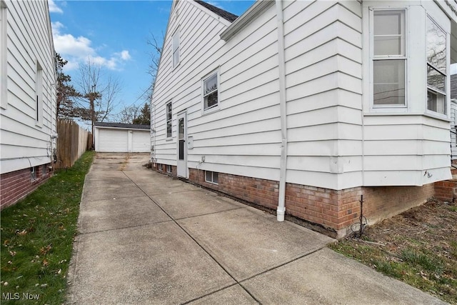 view of side of home with a garage and an outbuilding