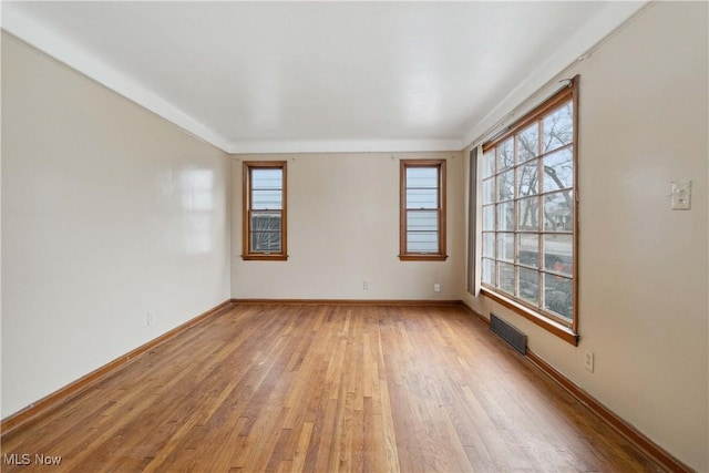 empty room with light hardwood / wood-style flooring