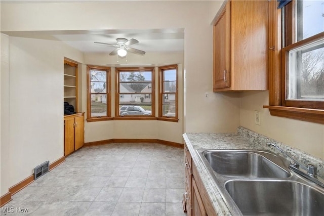 kitchen featuring ceiling fan and sink