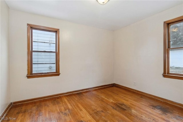 unfurnished room with wood-type flooring