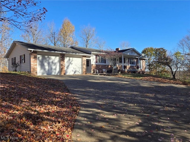 ranch-style house featuring a porch and a garage