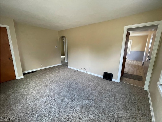 unfurnished bedroom featuring dark carpet