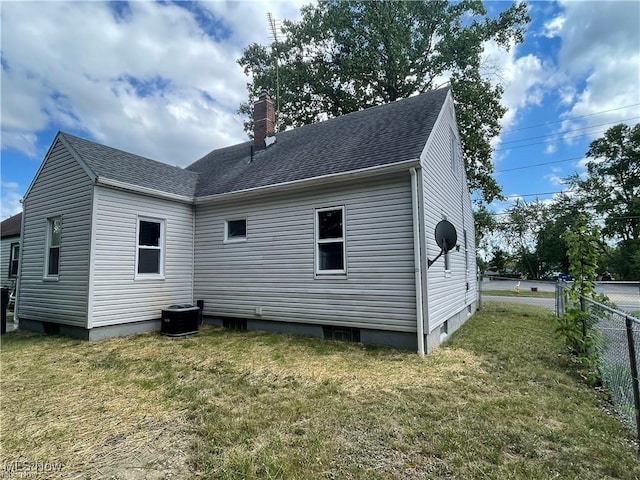 back of house with a yard and central AC unit