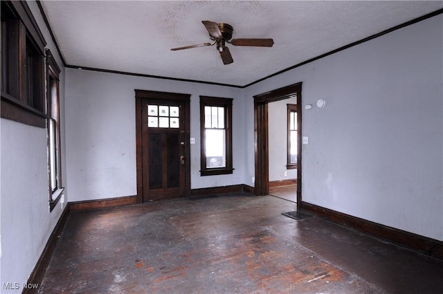 entrance foyer with a textured ceiling and ceiling fan