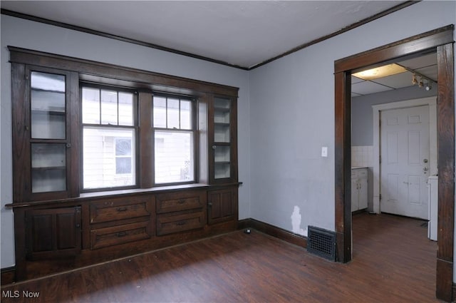 unfurnished room featuring crown molding and dark hardwood / wood-style floors