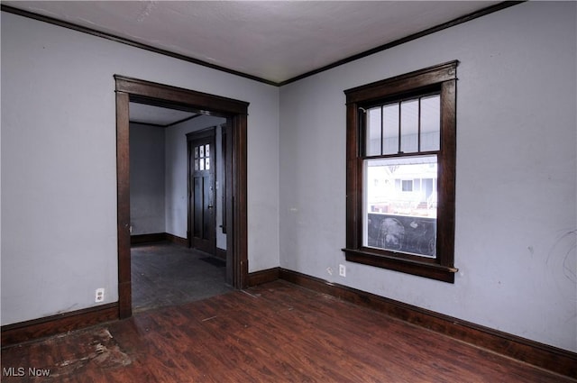 spare room with dark hardwood / wood-style floors and ornamental molding