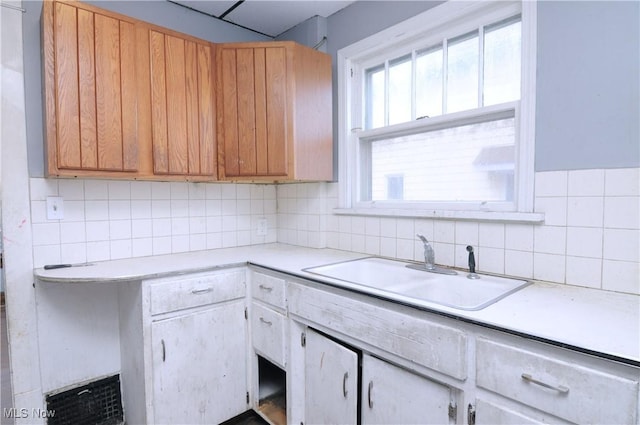 kitchen with tasteful backsplash and sink