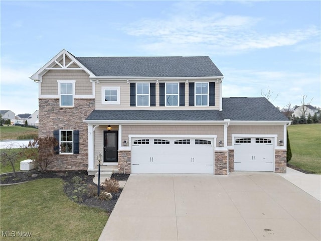 view of front of house featuring a front yard and a garage