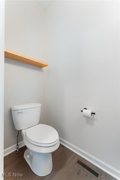 bathroom featuring hardwood / wood-style floors and toilet