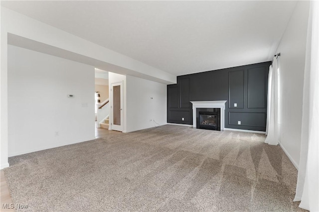 unfurnished living room featuring light carpet