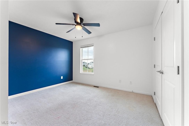 carpeted empty room with ceiling fan