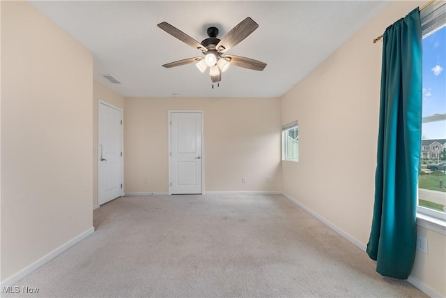 unfurnished room with light carpet and ceiling fan