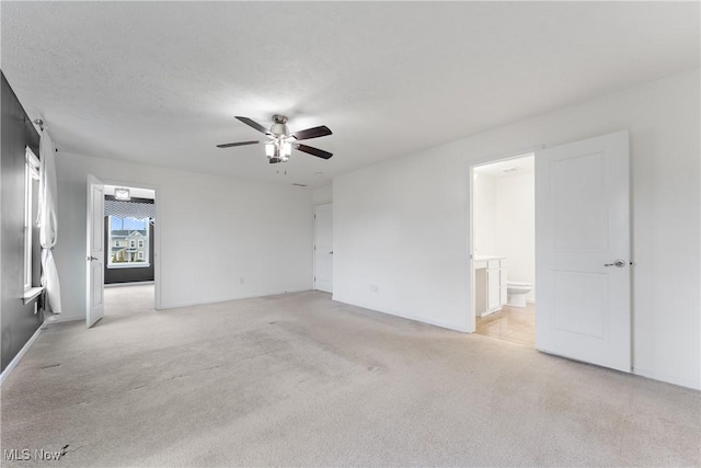 carpeted empty room with a textured ceiling and ceiling fan