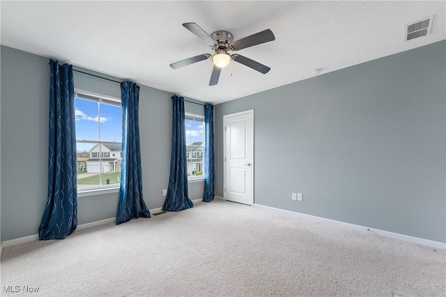 carpeted empty room featuring ceiling fan