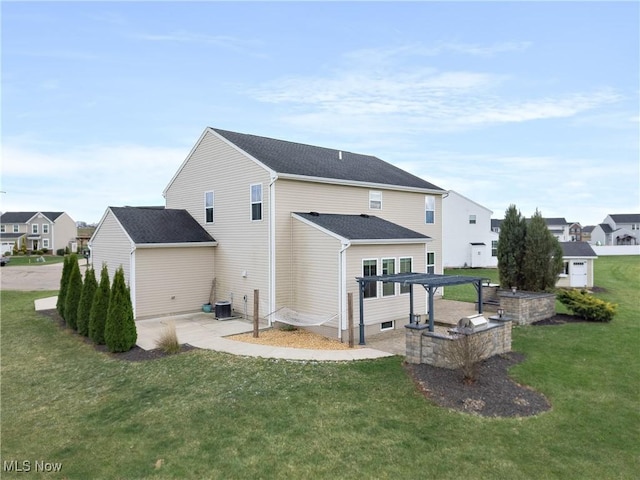 rear view of house featuring a lawn, central air condition unit, and a patio