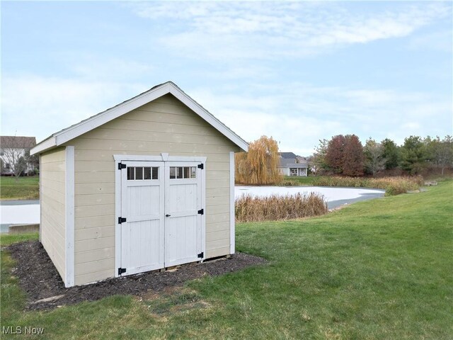 view of outbuilding featuring a lawn