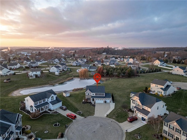 aerial view at dusk with a water view