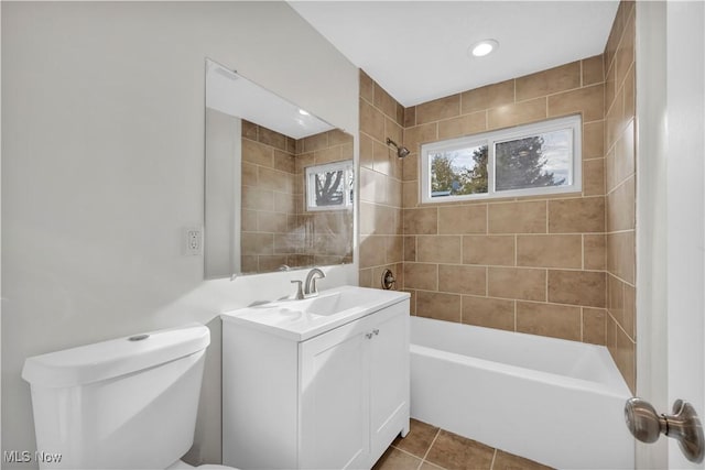 full bathroom featuring tile patterned floors, vanity, toilet, and tiled shower / bath combo