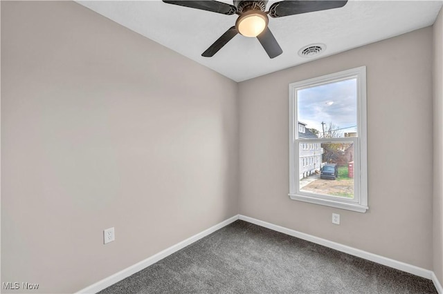 carpeted empty room featuring a wealth of natural light and ceiling fan