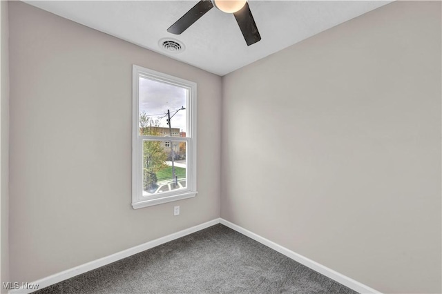 carpeted empty room featuring ceiling fan