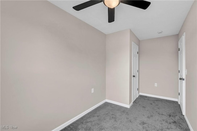 unfurnished bedroom featuring dark colored carpet and ceiling fan