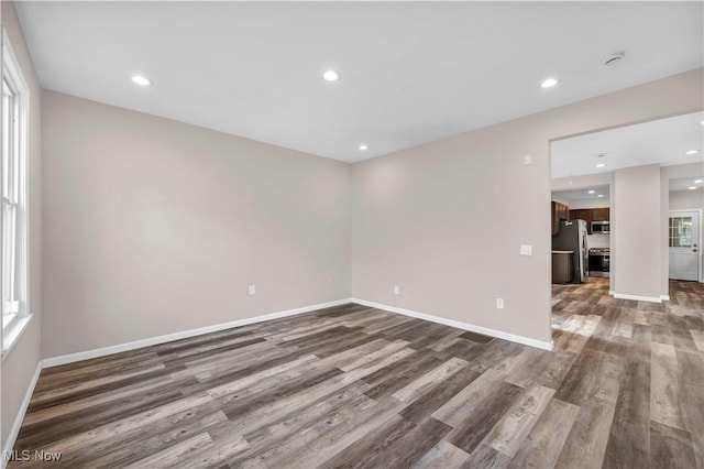 spare room with dark hardwood / wood-style floors