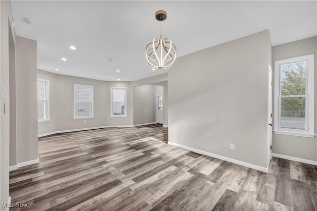 interior space with hardwood / wood-style floors and a chandelier