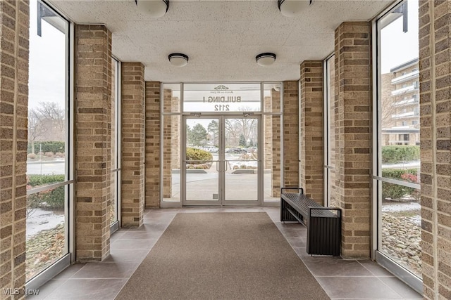 interior space with tile patterned floors and floor to ceiling windows