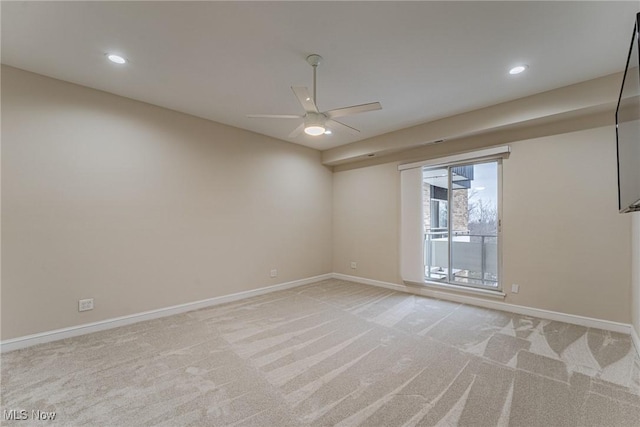 carpeted spare room featuring ceiling fan