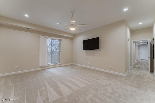 spare room with light carpet and ceiling fan