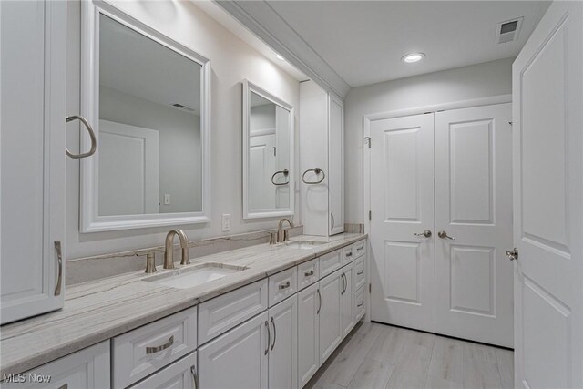 bathroom with vanity and hardwood / wood-style flooring