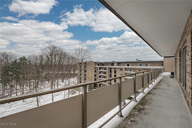 view of snow covered back of property