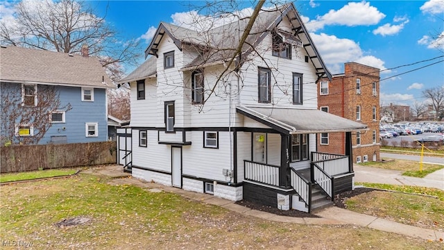 rear view of property with a lawn