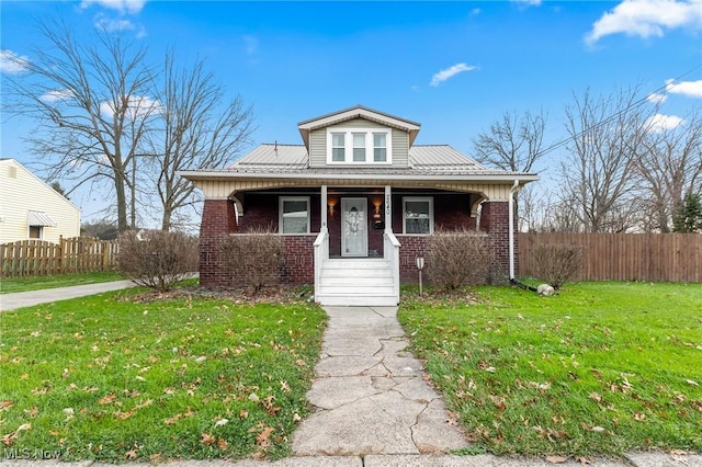 bungalow with a porch and a front lawn