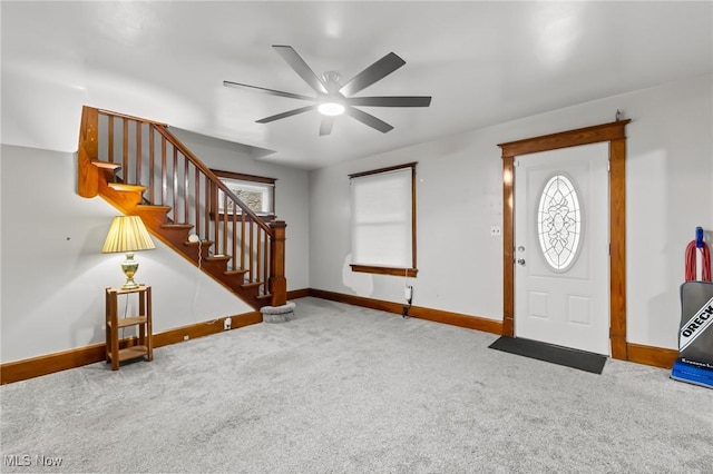 carpeted foyer featuring ceiling fan and a healthy amount of sunlight