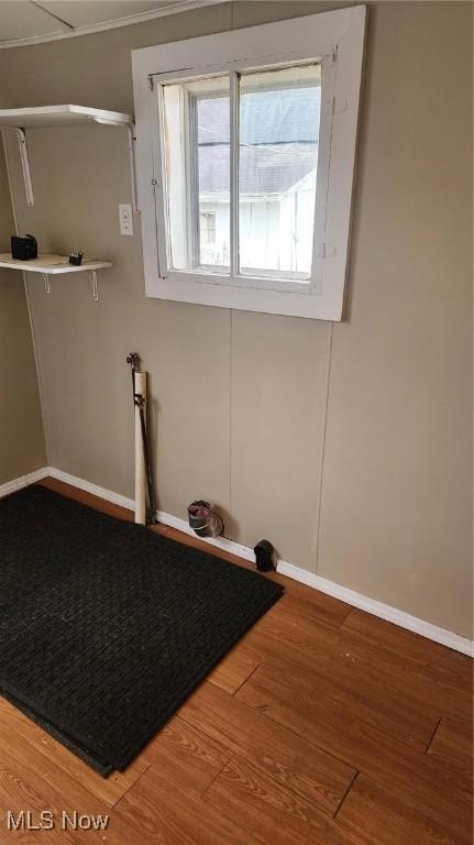 clothes washing area with hardwood / wood-style floors