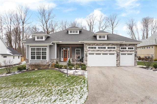 view of front of home with a front yard and a garage