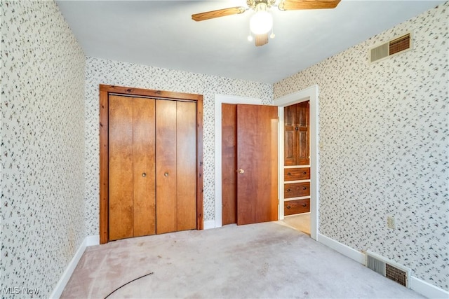 unfurnished bedroom with ceiling fan and light carpet