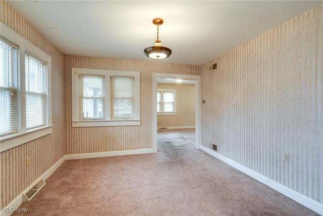 unfurnished room featuring light carpet