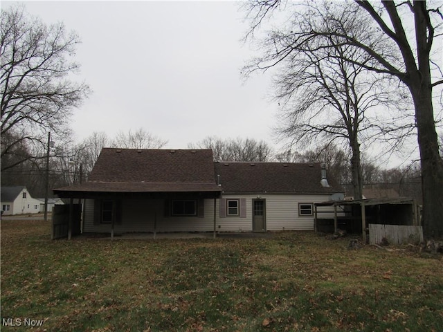 rear view of property with a lawn