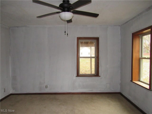 unfurnished room with carpet, ceiling fan, and a healthy amount of sunlight