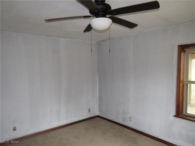 unfurnished room featuring light carpet and ceiling fan