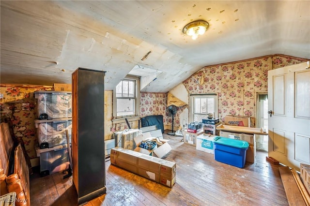 additional living space featuring plenty of natural light, wood-type flooring, and vaulted ceiling