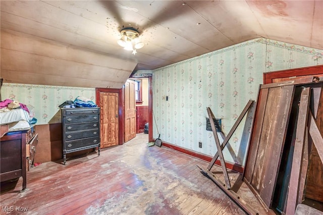 additional living space featuring light hardwood / wood-style flooring and vaulted ceiling