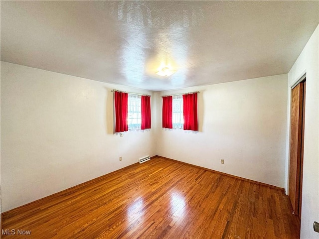 spare room with hardwood / wood-style flooring