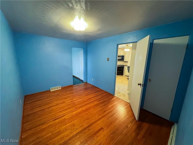 unfurnished bedroom featuring wood-type flooring