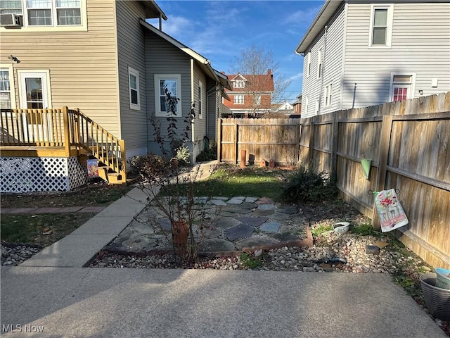 view of yard with a patio area and a wooden deck