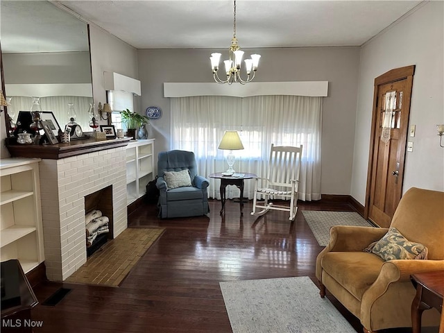 living area with a fireplace, a chandelier, and dark wood-type flooring