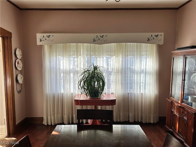 dining room featuring dark hardwood / wood-style flooring and ornamental molding