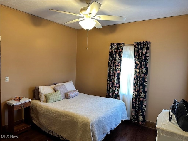 bedroom with ceiling fan, dark hardwood / wood-style flooring, and crown molding